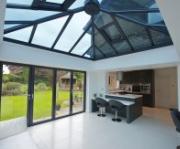 Inside grey aluminium orangery with bi-fold doors