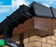 Dark teak roof-line with ogee gutter